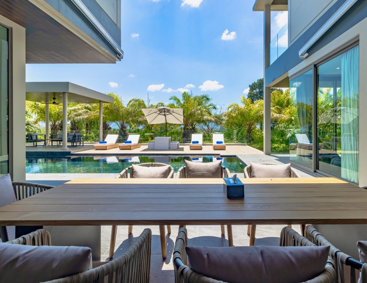 Outdoor dining overlooking the pool at Villa Lion